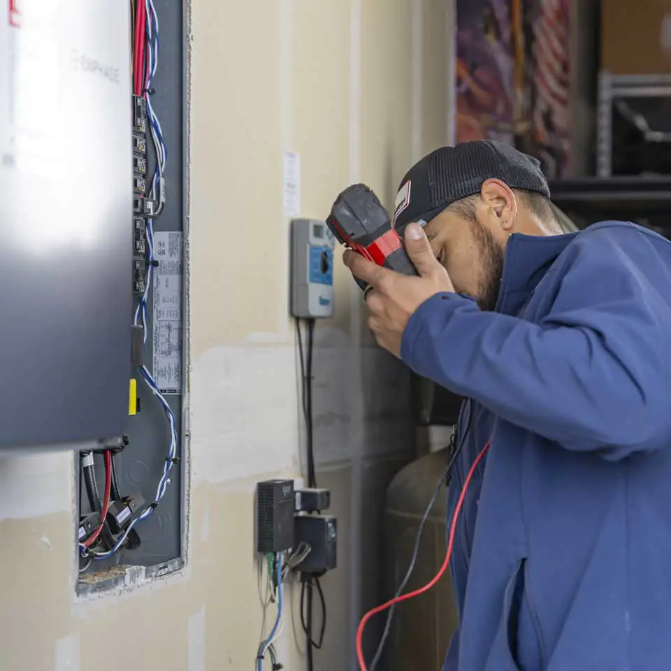 Electrician inspects wiring.