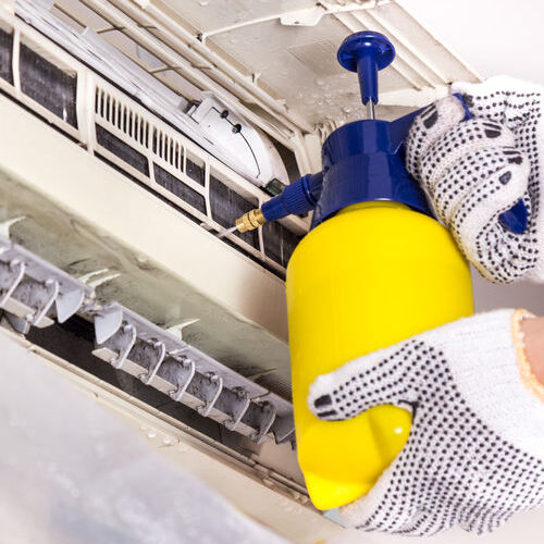 Technician cleans evaporative coils.