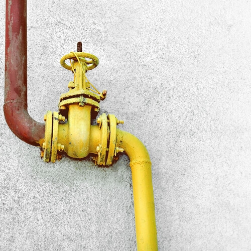 a yellow gas line on a wall